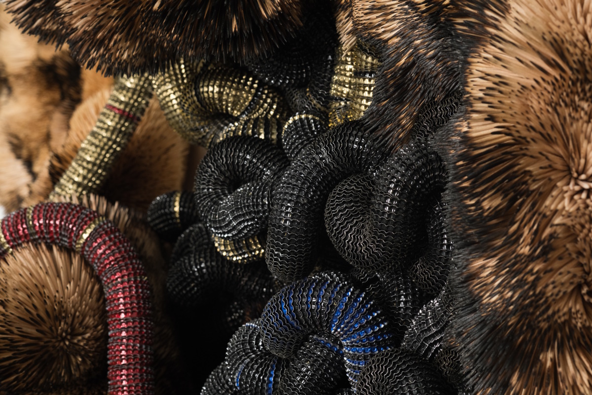 Chimera (detail), 2024, Discarded Beer Bottle Caps threaded onto Electric Fencing Cable, held in Polyurethane Sealant on Board, with Burnt and Unburnt Bamboo and Birch Wood Toothpicks, held in Polyurethane Sealant on Industrial Fabric on Board, 225 x 128 x 24 cm, Photographer: Matt Slater, Courtesy Piero Atchugarry Gallery and the Artist